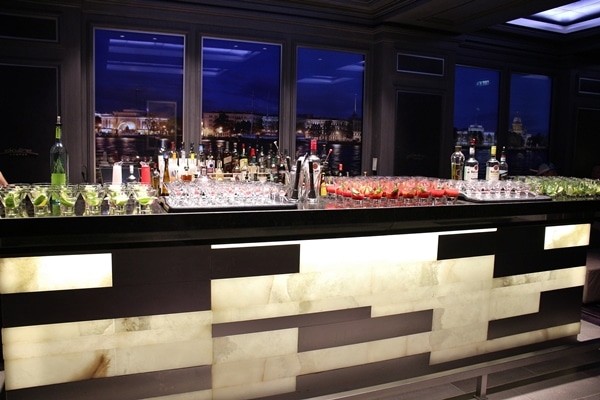 a bar topped with various glasses