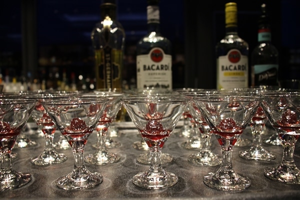 small cocktail glasses with cherry garnishes