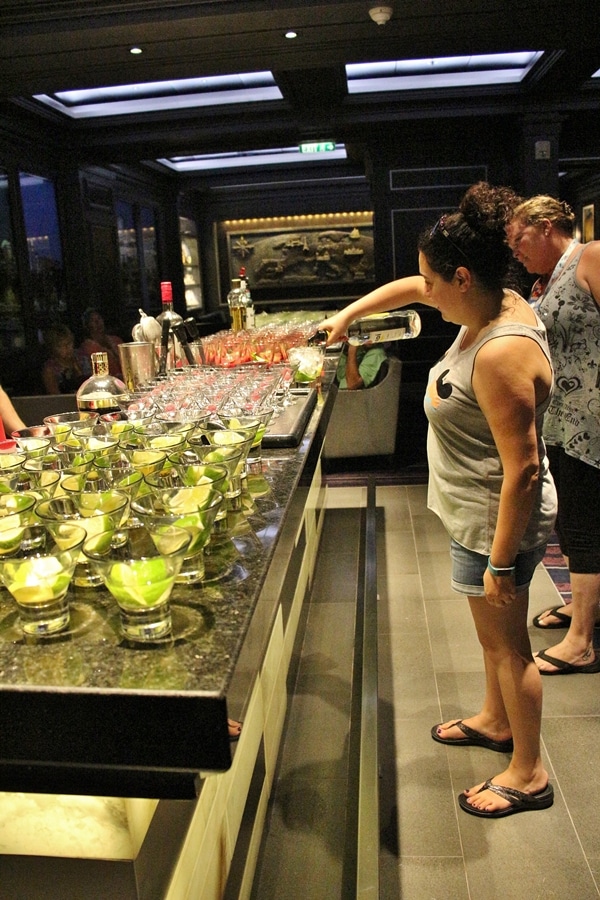 a woman pouring a drink at a bar