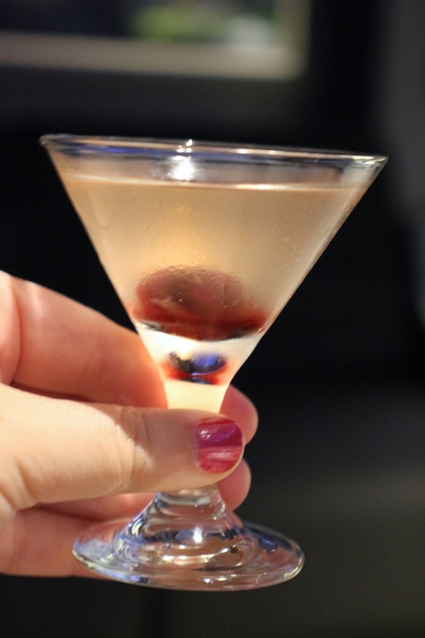 a small cocktail glass with a cherry garnish