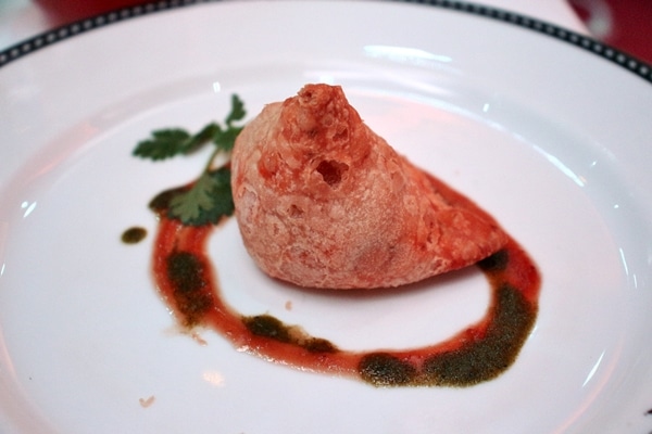 a samosa with sauce on a plate