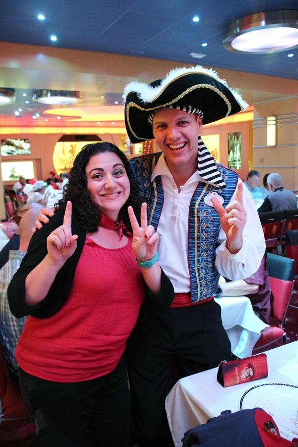 A woman posing with a man dressed as a pirate