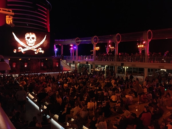 A group of people on the deck of a cruise ship at night