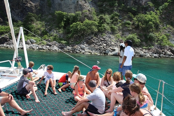 A group of people on a catamaran in the Caribbean