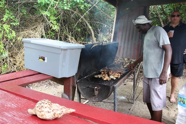 A man cooking food on a grill