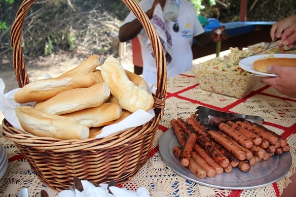 A basket of bread and platter of hot dogs