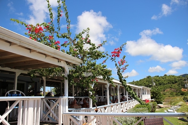 an open-air building covered with lush flowers