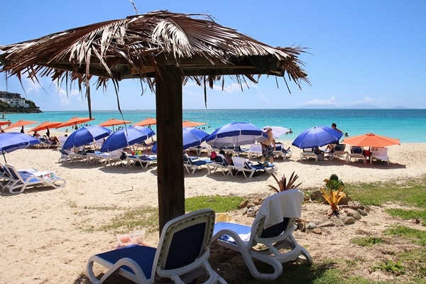 A group of chairs with umbrellas on a beach