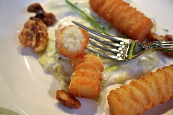 close up of potato croquettes on a white plate