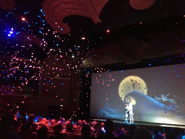 a movie screening in a theater with confetti falling down