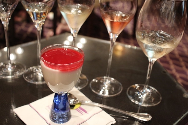 glasses of Champagne and a glass of panna cotta topped with raspberry puree