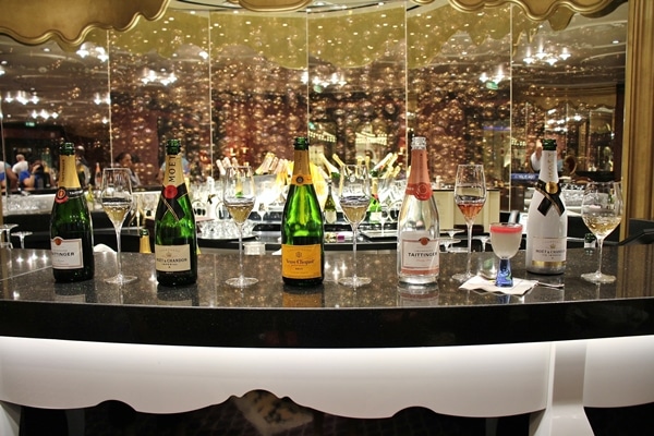 Champagne bottles lined up in the Ooh La La lounge on the Disney Fantasy