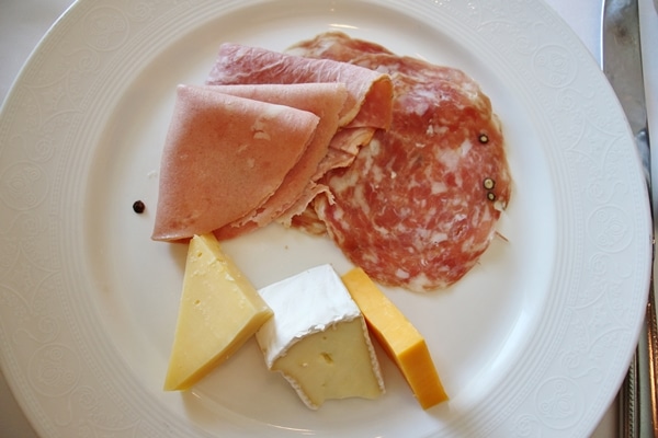 cold cuts and cheeses on a white plate