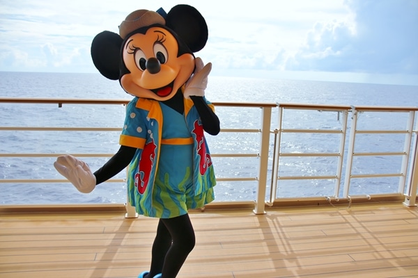 Minnie Mouse wearing her bathing suit on the deck of a cruise ship