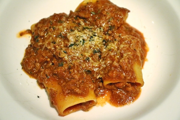 large tubular pasta with meat sauce and cheese on top