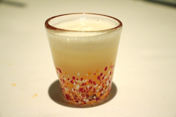 a small colorful shot glass filled with a drink