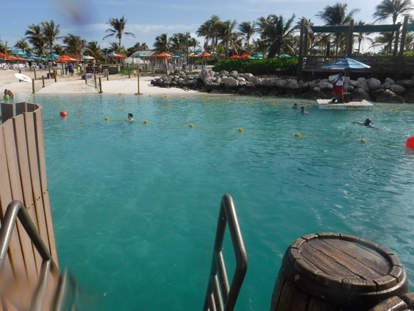 Bahamian beach with palm trees and colorful umbrellas