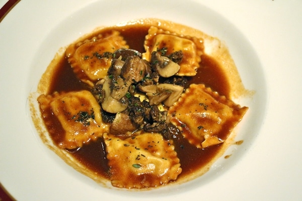 raviolis in a brown sauce with mushrooms