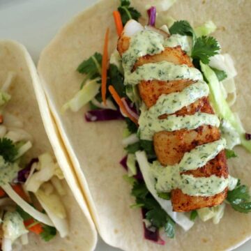 grilled fish tacos with citrus slaw and cilantro-lime mayo on flour tortillas