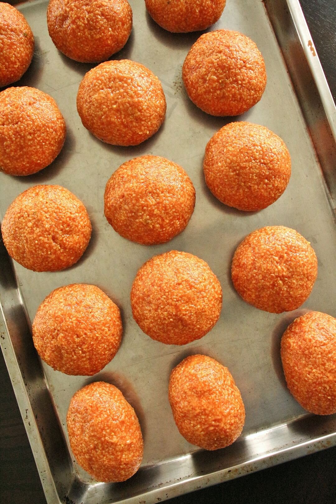 A tray of round ishli koftes with a few oval-shaped koftes