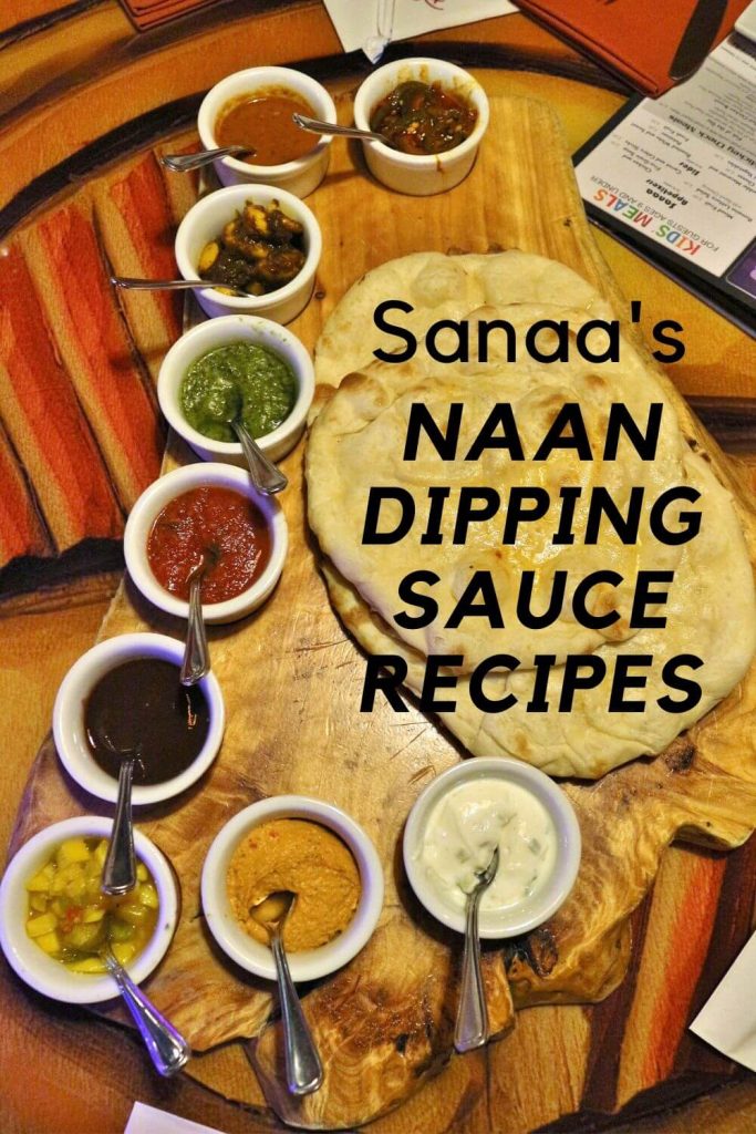 Sanaa's bread service featuring naan, and 9 dipping sauces on a wooden platter