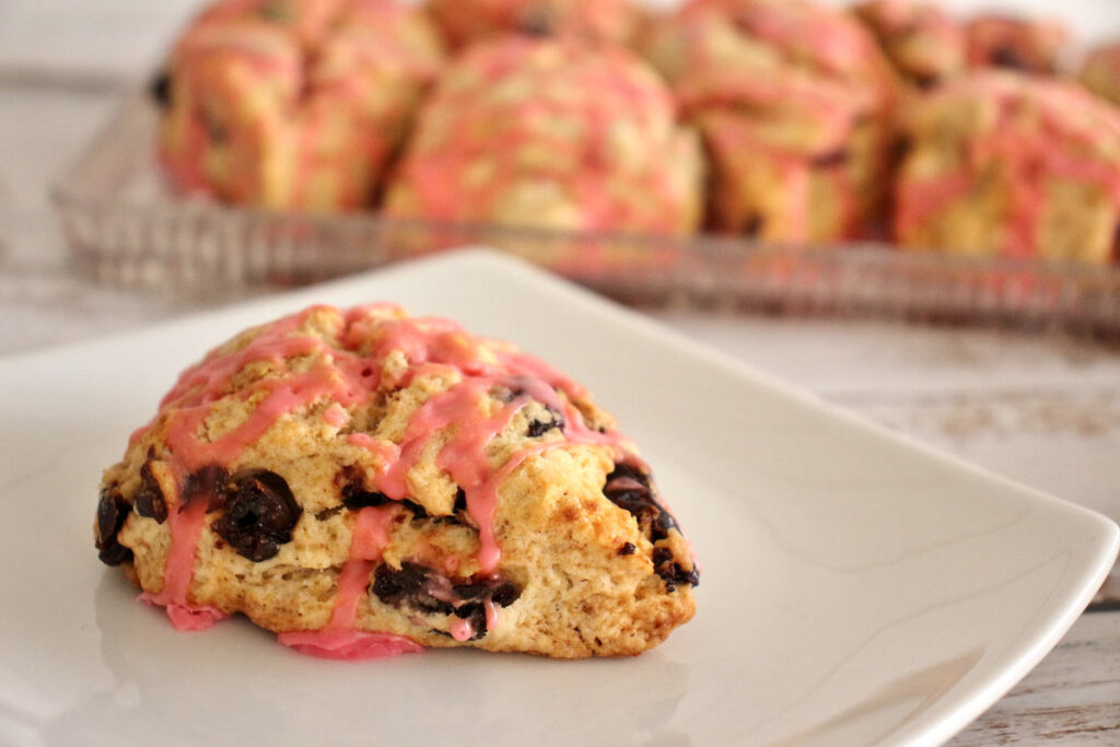 A cherry scone drizzled with pink glaze
