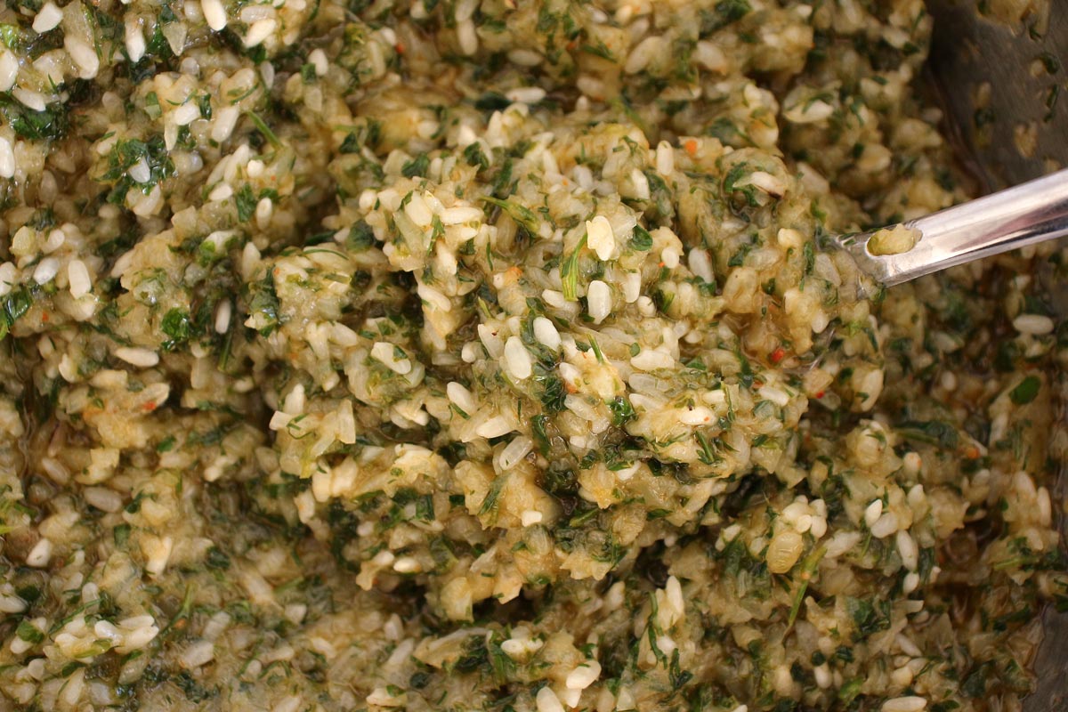 A bowl of rice and herb filling for vegetarian stuffed grape leaves (yalanchi)