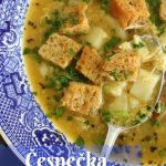a bowl of cesnecka (Czech garlic soup) with rye croutons in a wide blue bowl