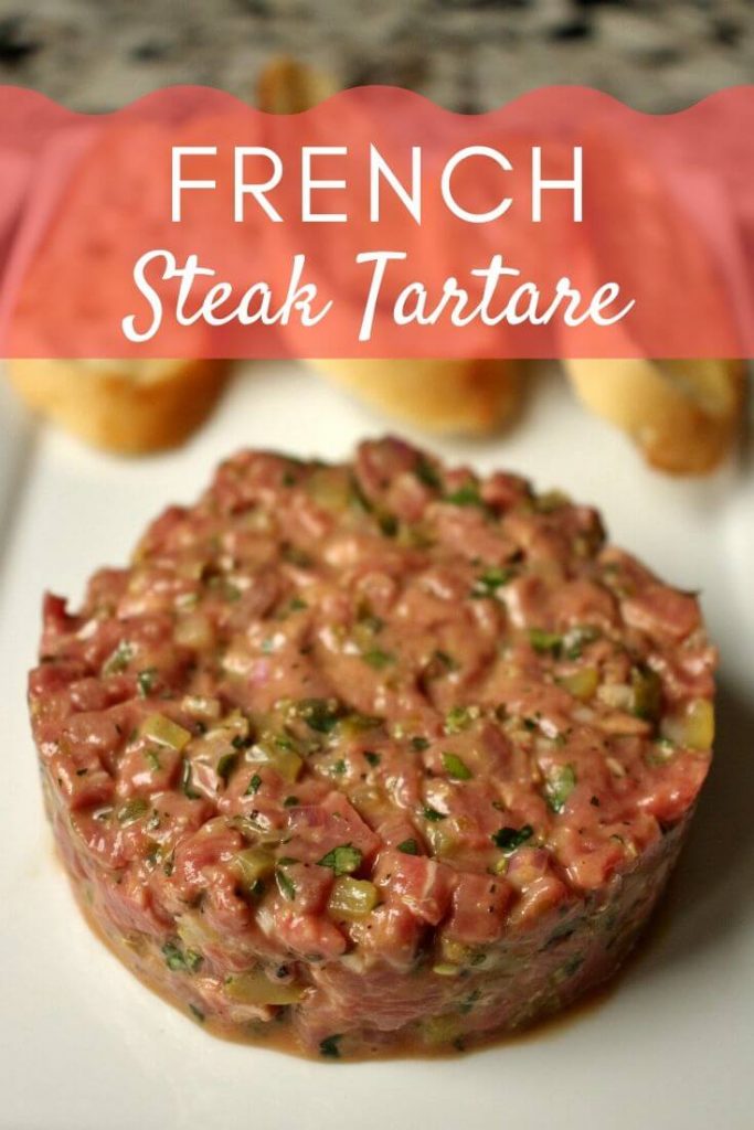 French steak tartare served on a white rectangular plate