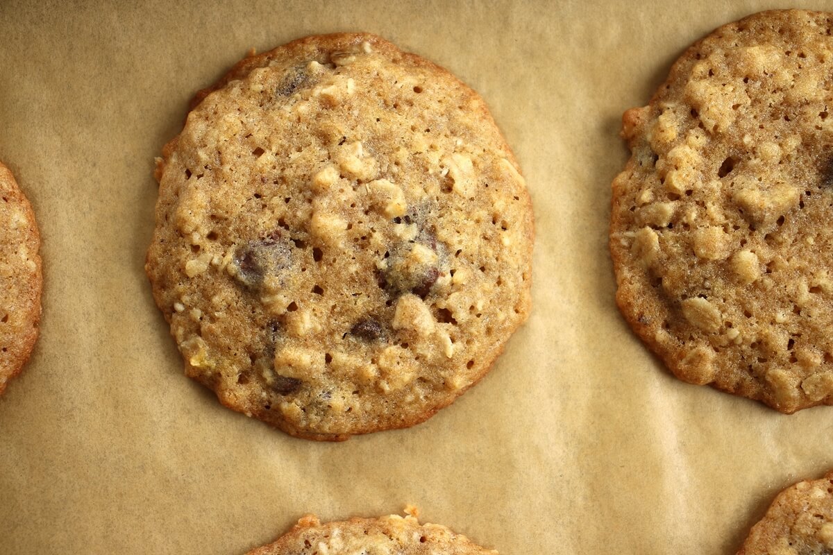 A close up of baked banana oatmeal chocolate chip cookies on a baking sheet