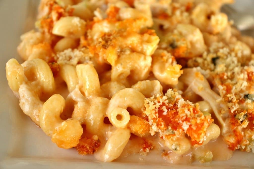 Closeup of a serving of baked buffalo chicken macaroni and cheese on a plate