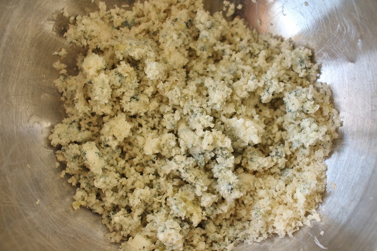 A mixture of panko, garlic, and blue cheese in a mixing bowl