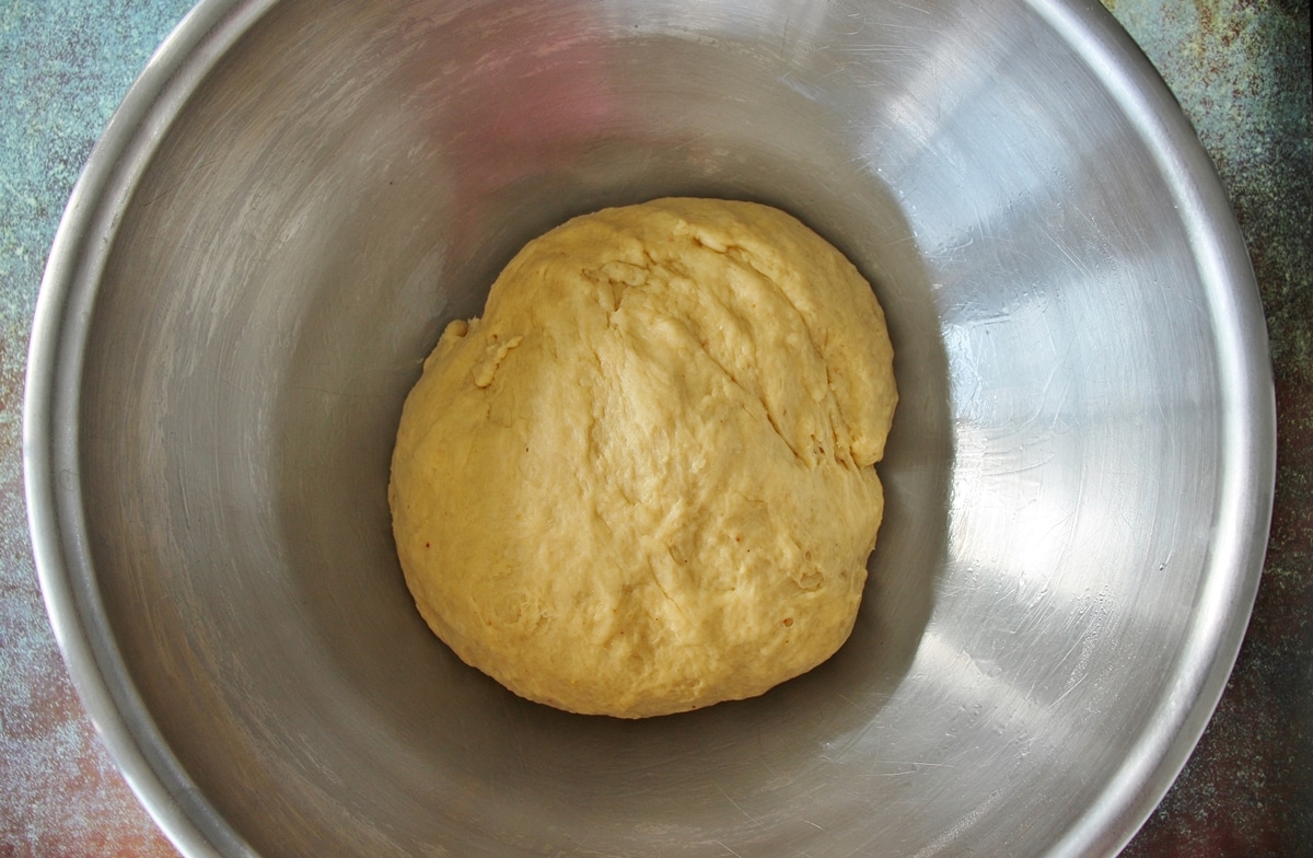 Chorek dough in a large metal mixing dough, prior to proofing.