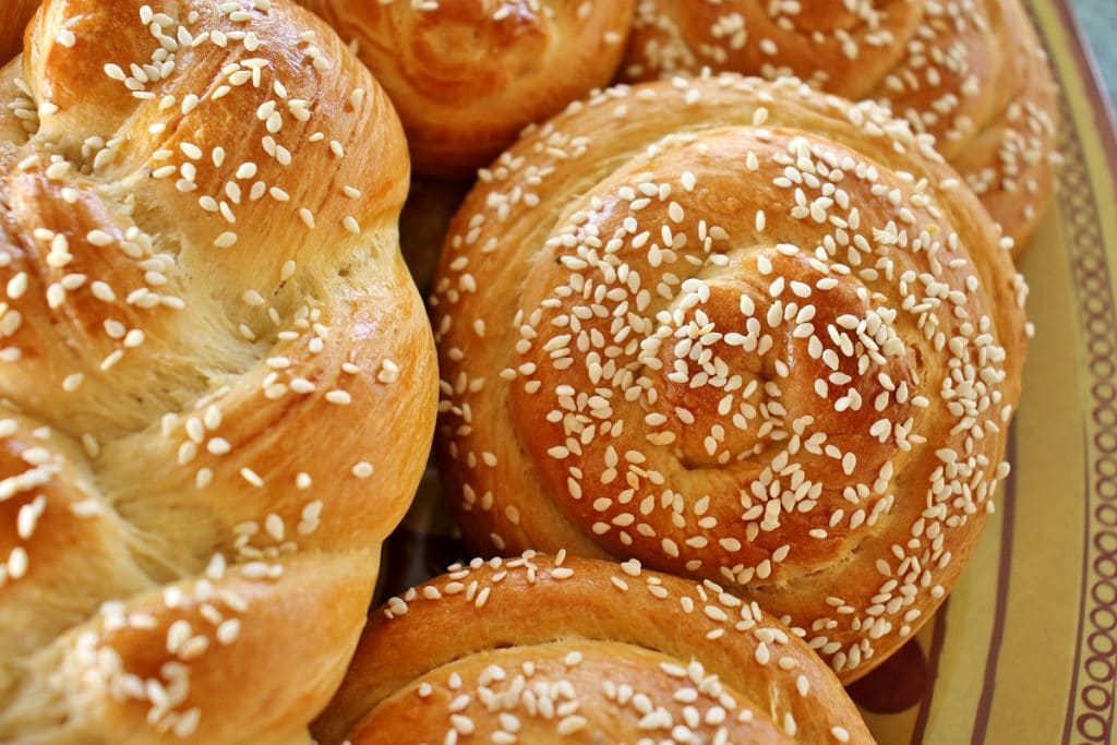 Closeup of spiral-shaped Armenian sweet bread (chorek) topped with sesame seeds