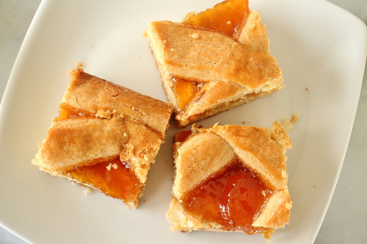 3 squares of apricot pirog on a white plate