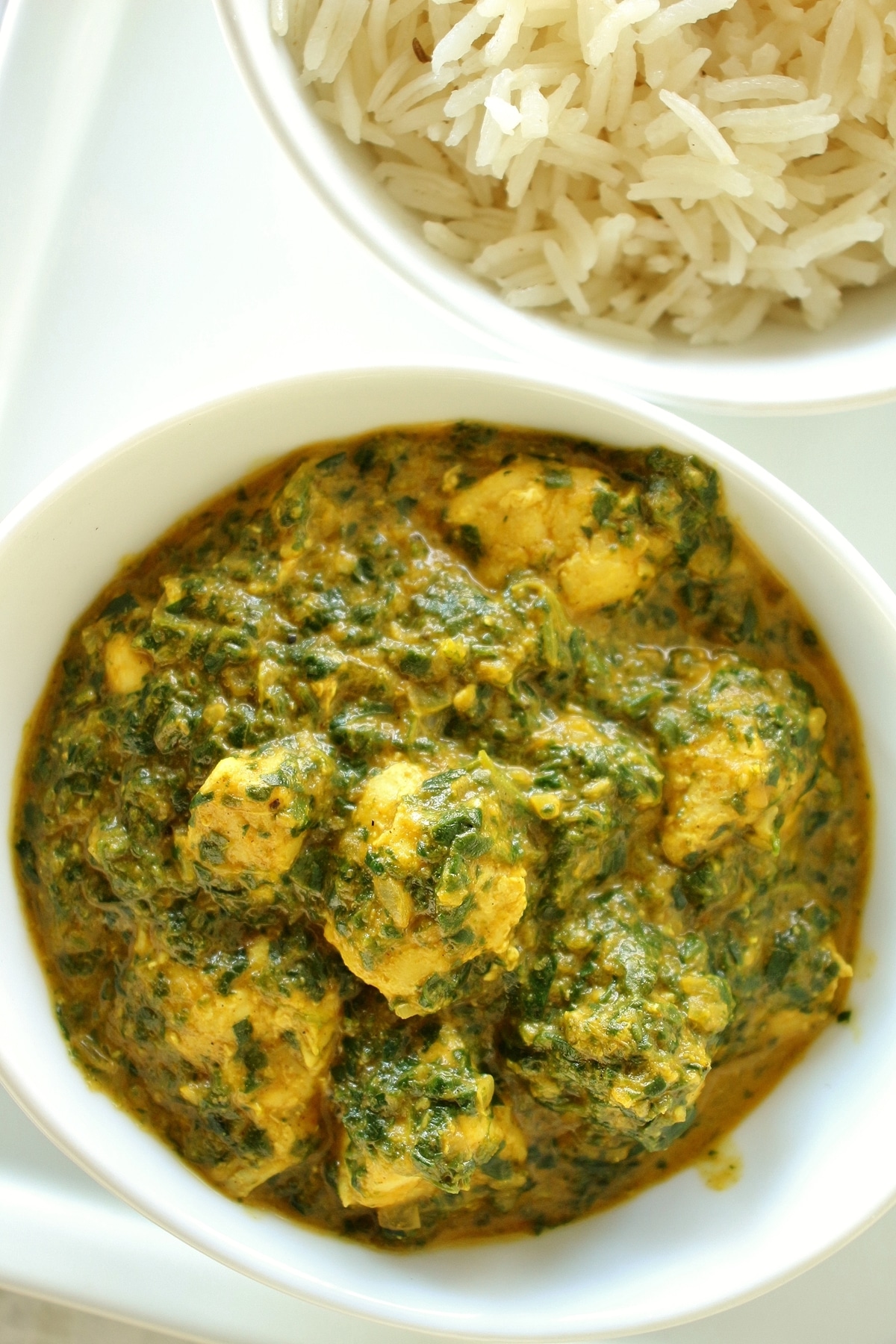 closeup of chicken saag in a small white bowl