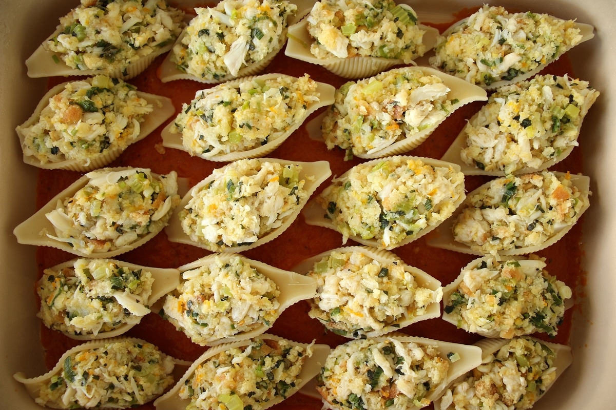 Crab stuffed shells arranged in a rectangular casserole dish