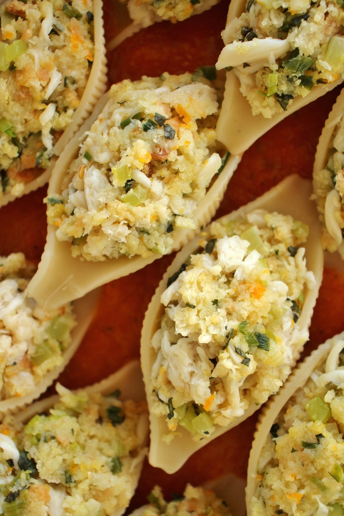 A close up of crab stuffed pasta shells in a casserole dish