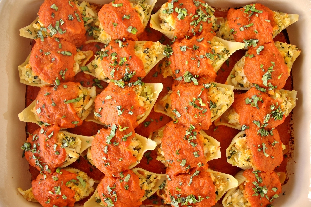 Crab stuffed shells arranged in a rectangular casserole dish, after baking.