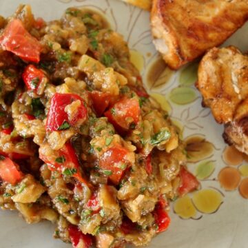 grilled vegetable salad on antique plate with pork chops