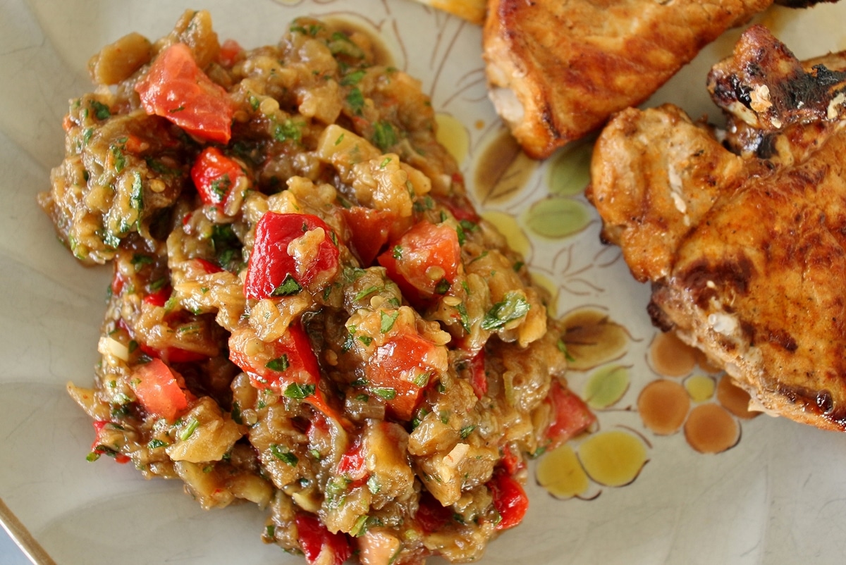 grilled vegetable salad on antique plate with pork chops