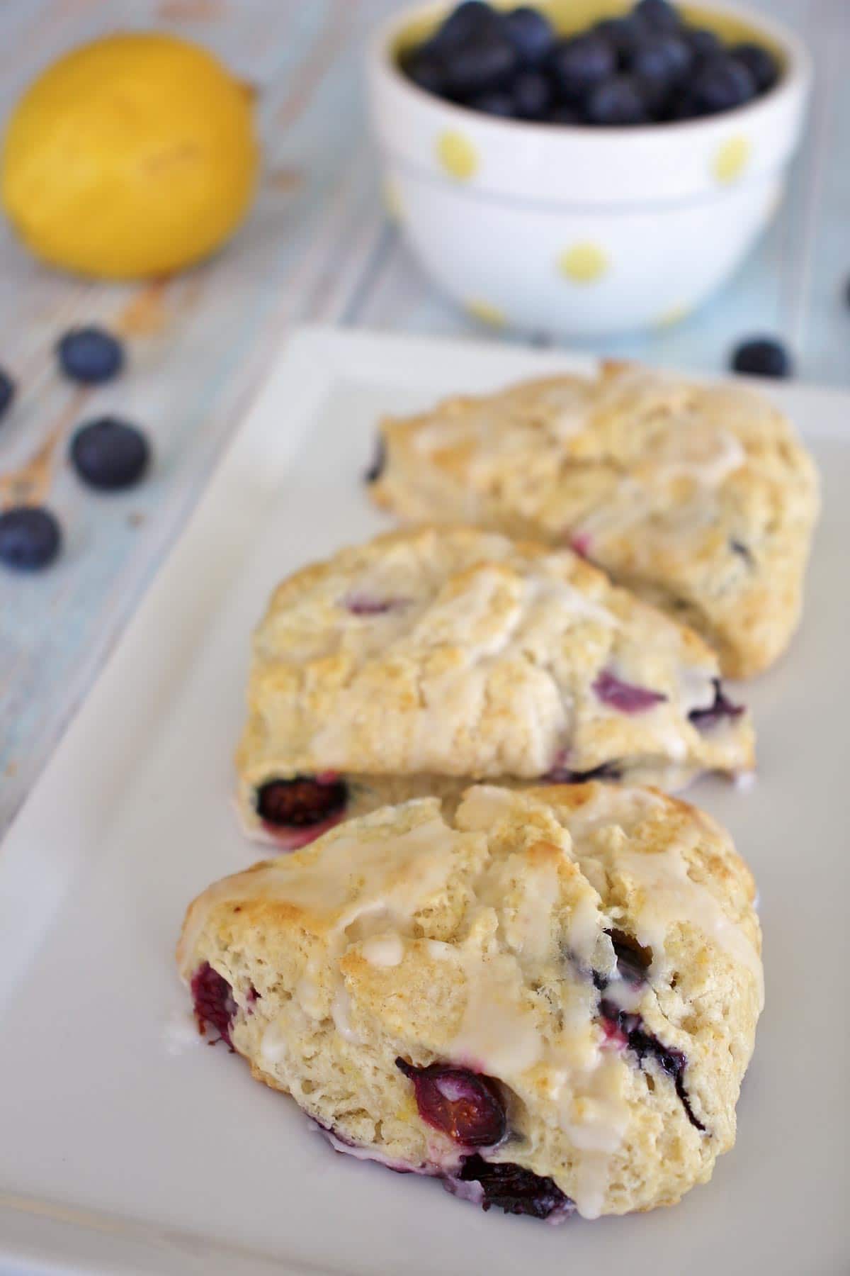 3 blueberry lemon scones on a rectangular white plate