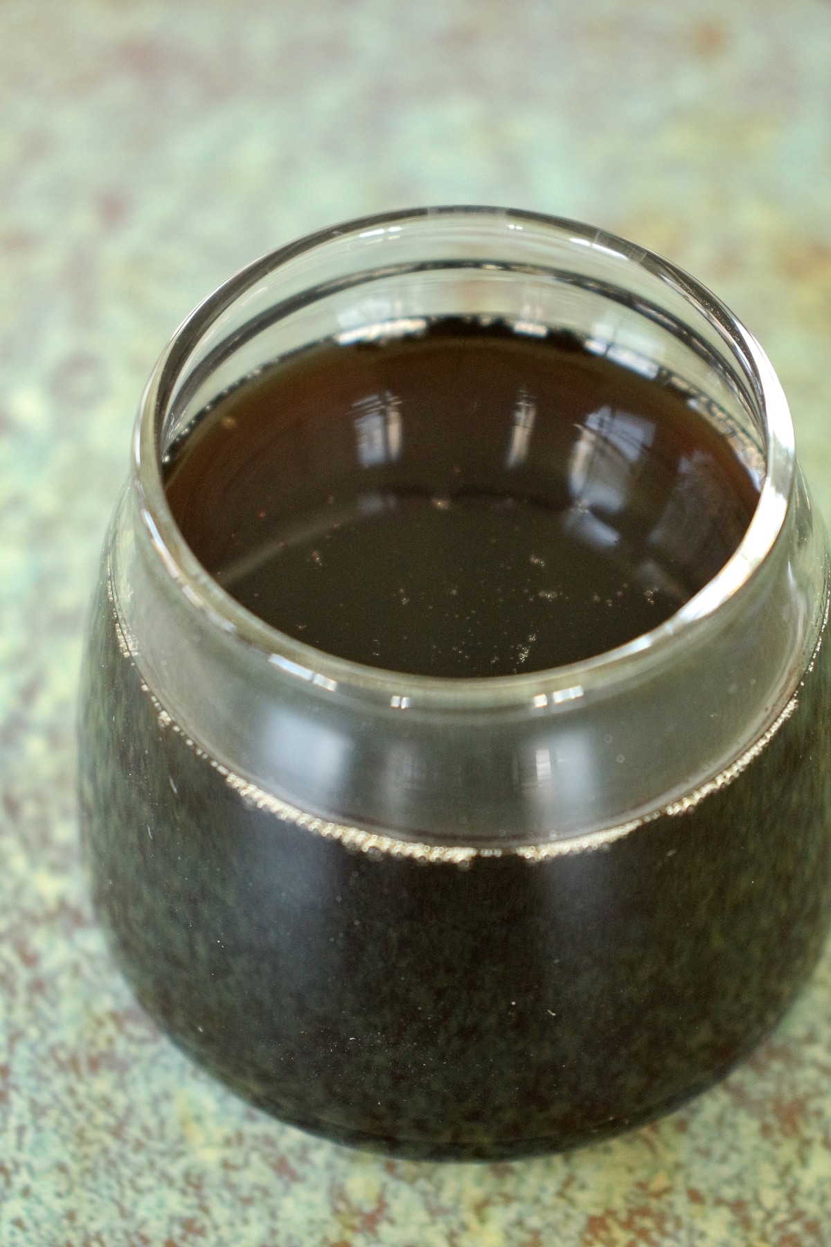 Homemade tamarind simple syrup served in a tiny jar