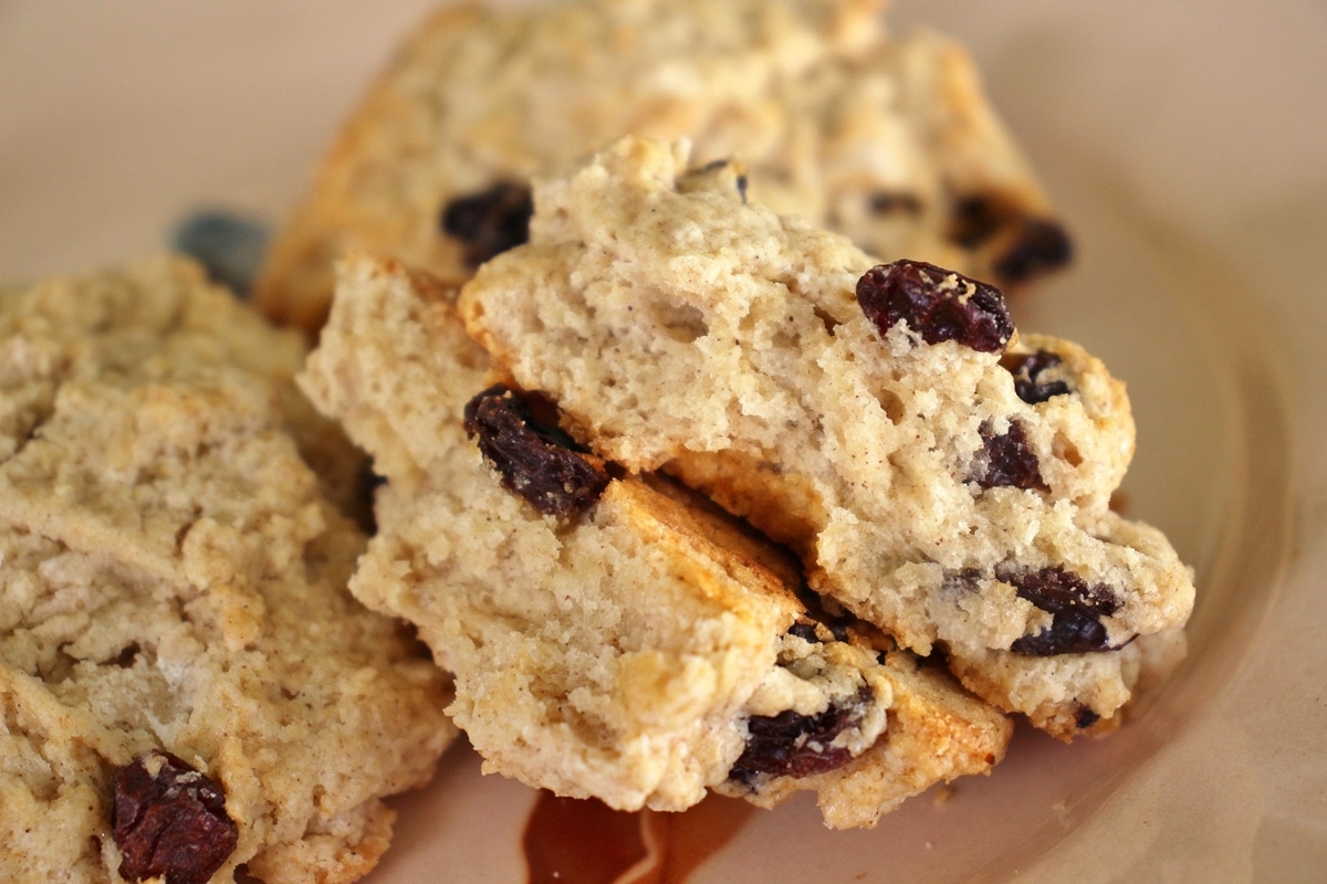 close up of a raisin filled rock cake broken in half to show the inside