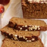 closeup of sliced Irish Guinness brown bread with oats on a wooden board