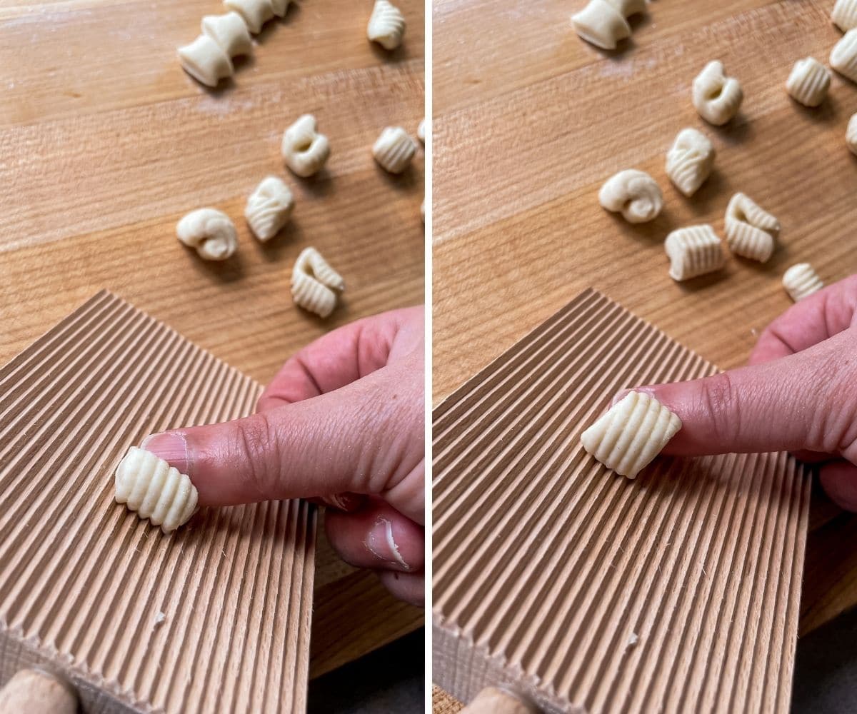 A thumb rolling a small piece of dough over the ridges on a gnocchi board.
