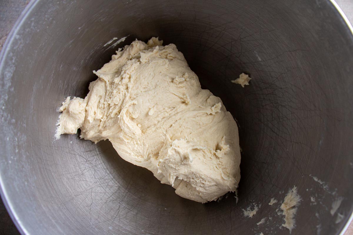 Dough in a metal mixing bowl.