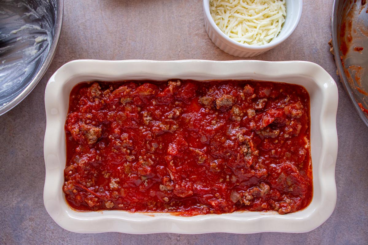 The top layer of meat sauce in a small lasagna.