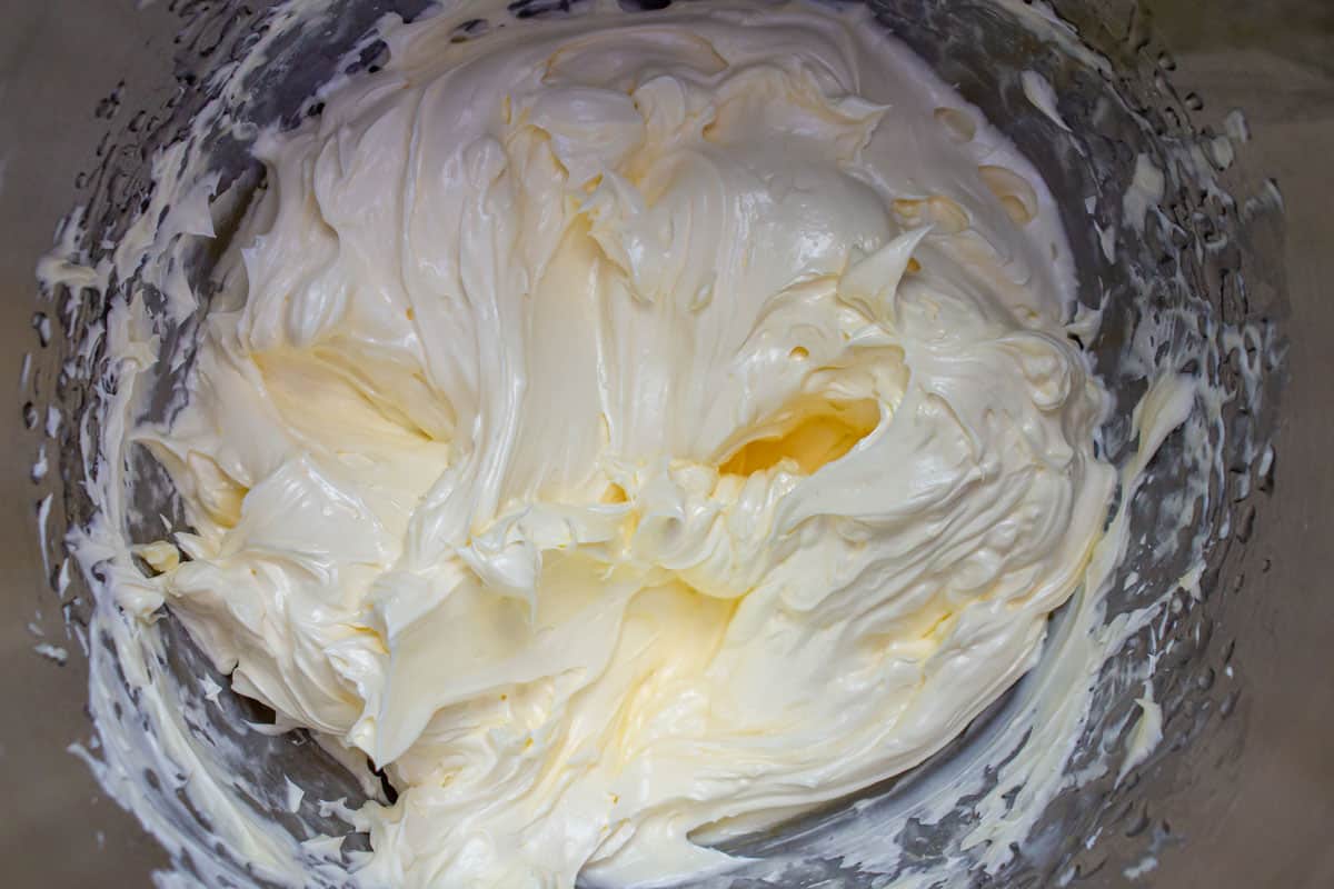 French buttercream frosting in a metal mixing bowl.