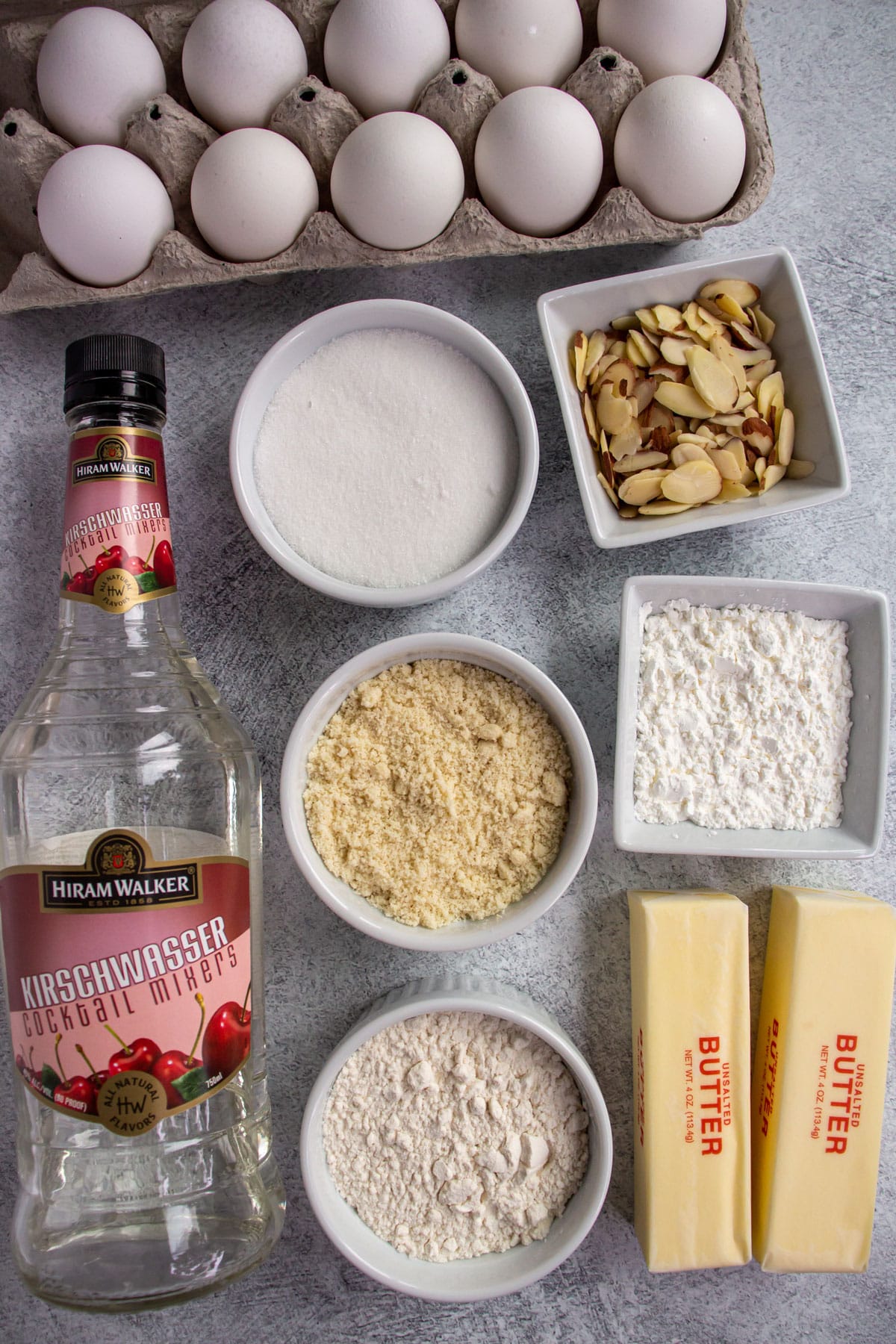 Ingredients for Zuger Kirschtorte on a greyish white background.